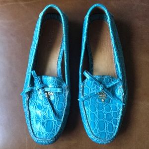 Blue Prada loafers with gold logo